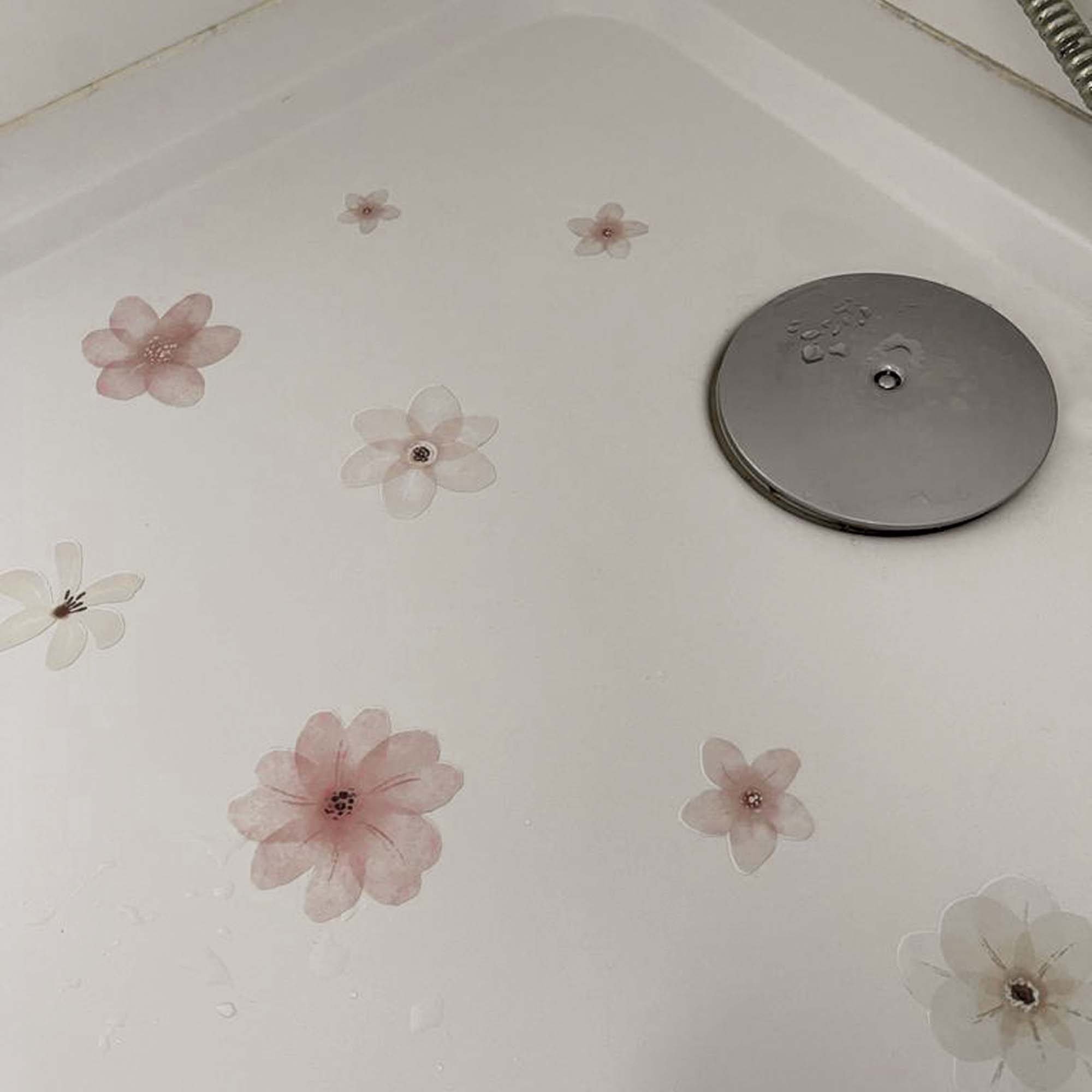 Foto mostrando cómo las pegatinas de flores rosas permanecen firmemente adheridas incluso con el flujo de agua durante la ducha - Nicolasito